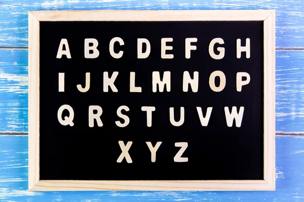 Wooden english alphabet A-Z on the blackboard. — Stock Photo, Image