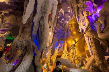 Nakhon Nayok, Tayland - 28 Mart 2021: Naga Mağarası 'nda Naga Nayok, Tayland' daki Maniwong Tapınağı 'nda ibadet eden ve şans dileyen büyük Buda.