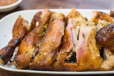 Grilled chicken marinated with spices, herbs and grilled on a charcoal stove.Eat with spicy sauce, very delicious.