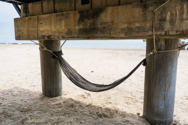 Hammock at Bottom view of an old pier in beautiful blue water