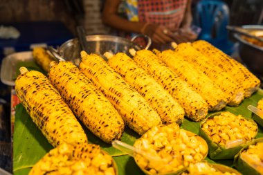 Sweet corn with butter grilled on the charcoal stove in the market.Thailand