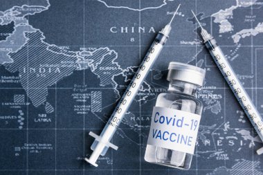 İğne, iğne, dünya haritası, yakın çekim. Aşı tıbbi konsepti COVID-19. İnsanlığın umudu kavramı.