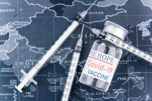 Injection syringe, needle, world map , close up. Vaccine medical concept COVID-19.Concept of humanity\'s hope