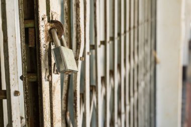 Eski ana anahtar demir kapıya kilitlendi, asma kilit, seçici odağı kapat, arka plan bulanıklığı.