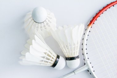 Beyaz bir arka plan üzerinde badminton aksesuarları