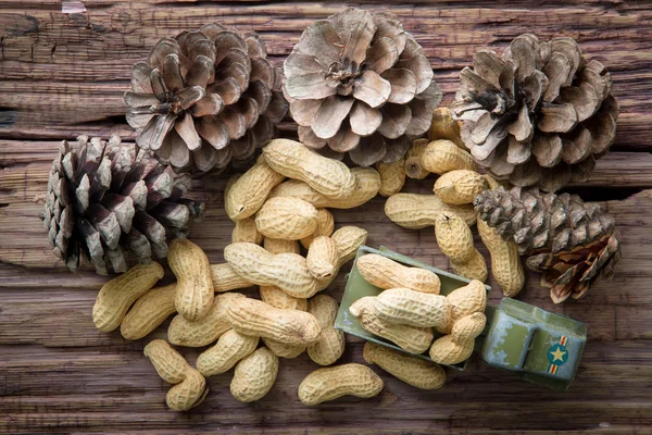 Peanuts drying and pine nuts on the wooden table