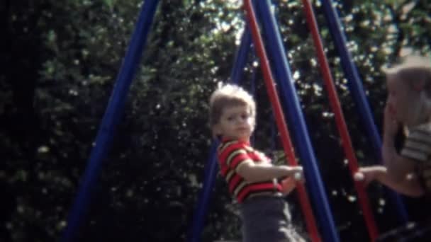 Kids on playground backyard see saw swing — Stock Video