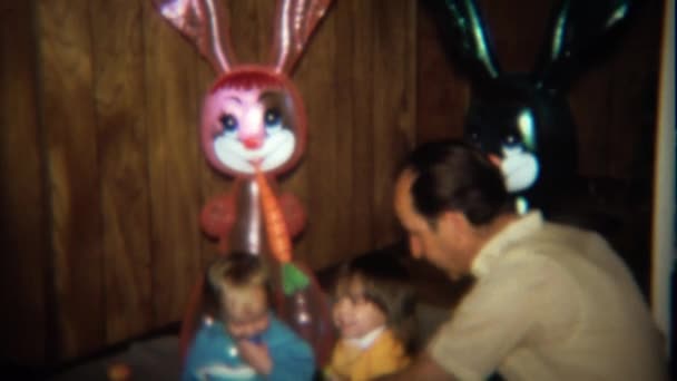 Grandpa plays with blow up Easter bunny dolls and kids — Stock Video