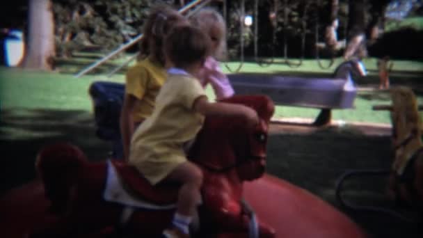 Kids on merry go round outdoor — Stock Video