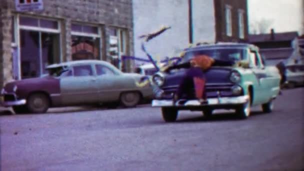 Mannequin strapped to decorated parade car hood — Stock Video