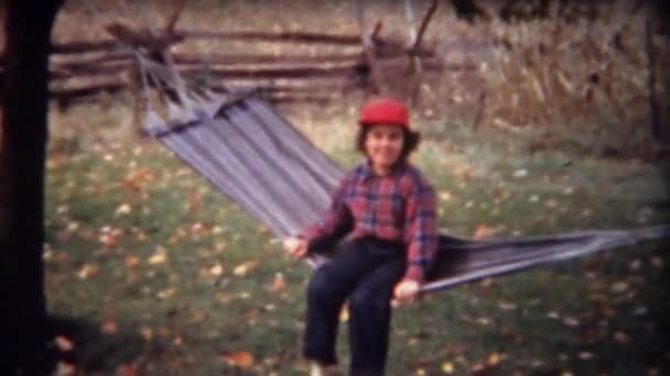 Girl rocking on hammock hanging — Stock Video