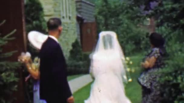 Wedding party leaves church outside reception — Stock Video