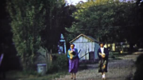 Mother and daughter walking back from local market — Stock Video