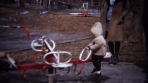 Kids playing on rotating playground carousel — Stock Video
