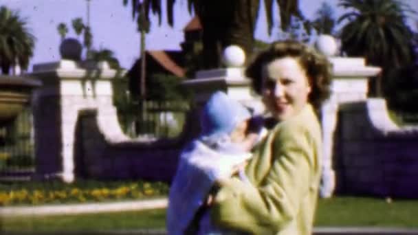 Mother bouncing newborn baby outdoor — Stock Video