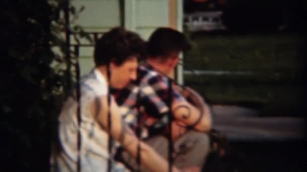 Couple sitting on suburban front porch — Stock Video