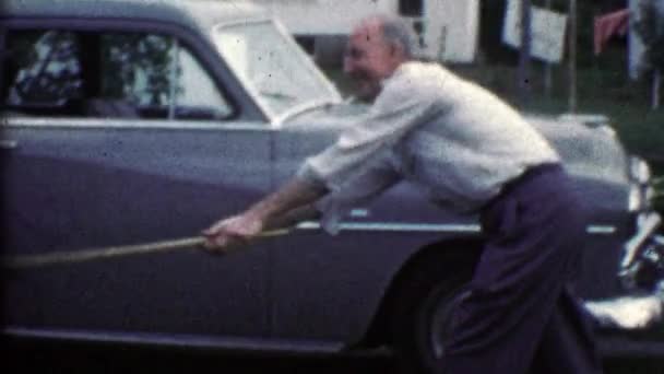 Grandpa playfully spanks kid with broom — Stock Video