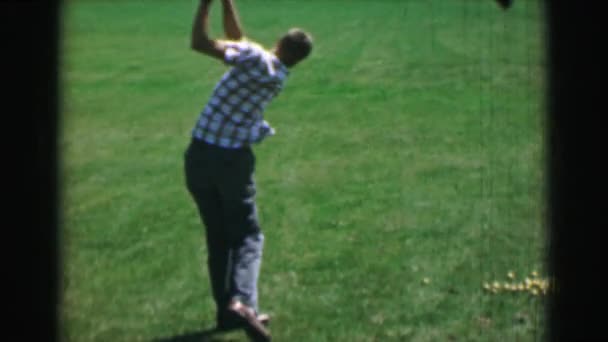Boy swinging golf club — Stock Video