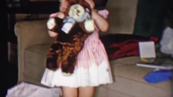 Girl hiding behind stuffed bear toy — Stock Video