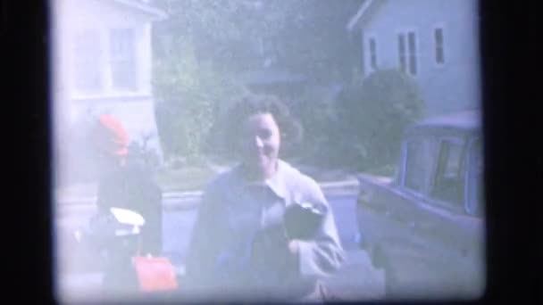 Woman smiling while a few kids wait for the ice cream man — Stock Video