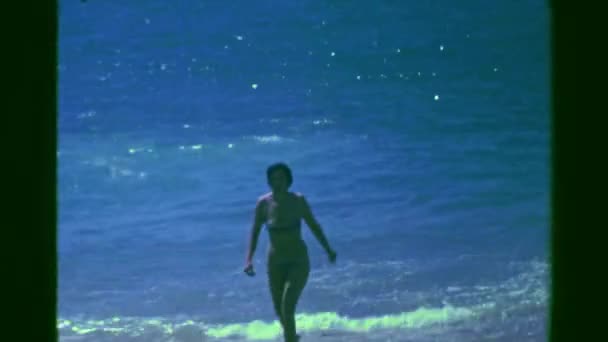 Swimming woman coming out of ocean beach — Stockvideo