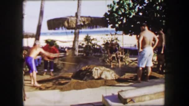 Pig roast Hawaiian shoveling dirt on burying food — Stock Video