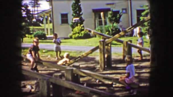 Kids plays with wood see saw teeter totter — Stock video