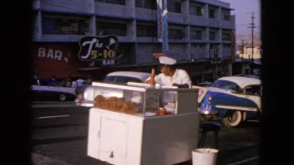 Street food seller watching cars passing by — Stock Video