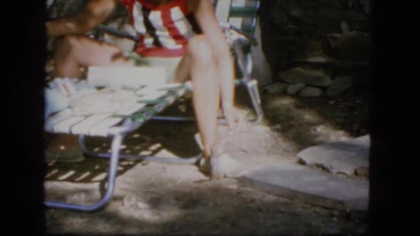 Female adult is straddling a piece of outdoor lounging equipment — Stock Video