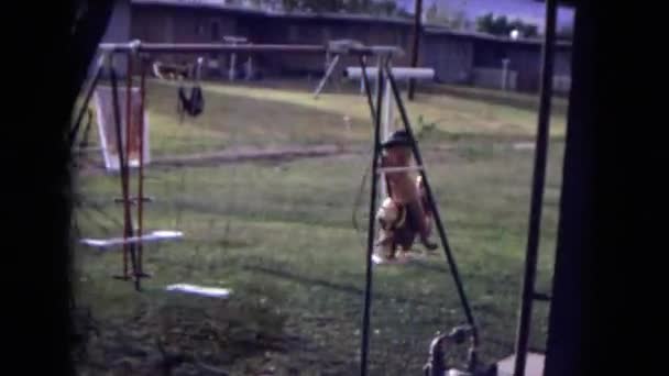Girl in a western hat swinging on a swing set — Stock Video