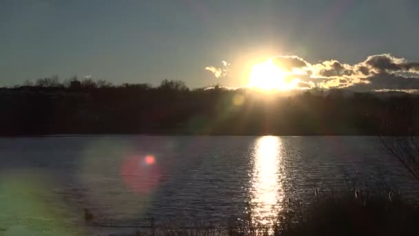 Puesta de sol sobre el lago congelado parcial — Vídeo de stock