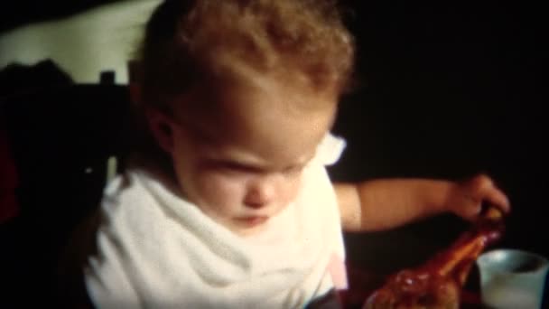 Baby gets a hold of a turkey leg — Stock Video