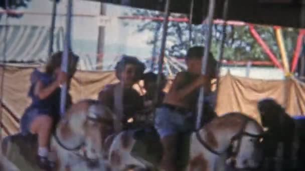 Dad holding daughter on horse carousel — Stock Video