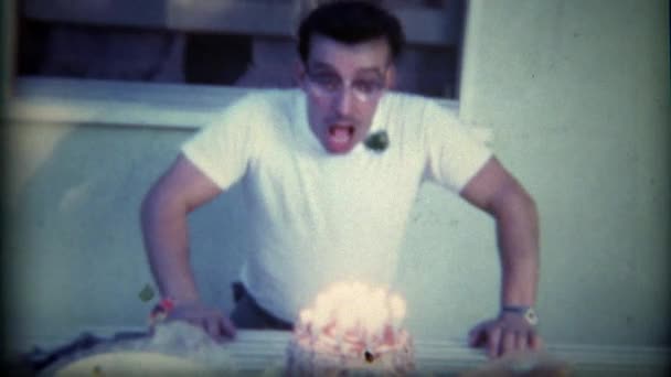 Man blows out birthday cake candles — Stock Video