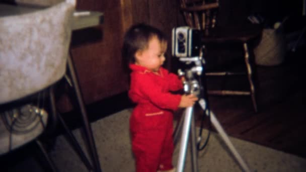 Toddler photographer looks at movie camera — Stock Video