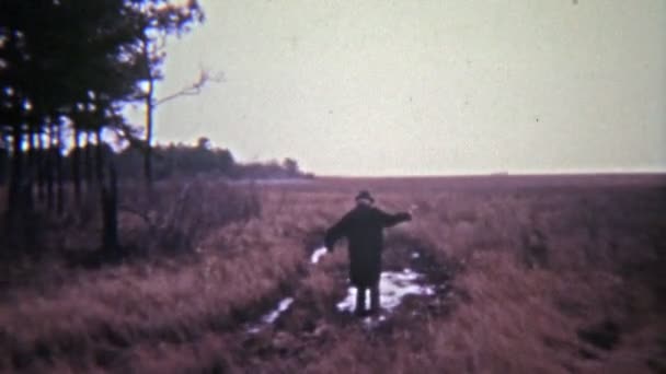 Man lopen door modder — Stockvideo