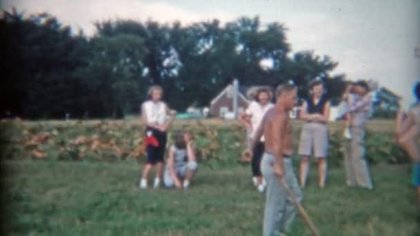 Men playing family baseball in farm fields — Stock Video