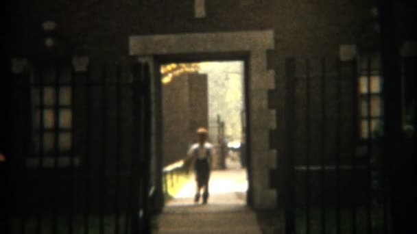 Boy leaving Catholic school headed home — Stock Video