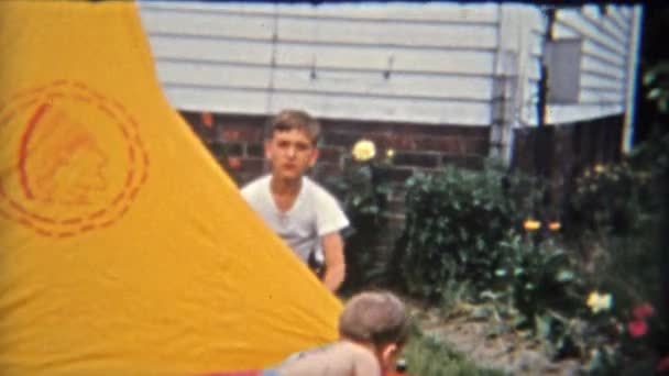 Boy setting up scouting tent — Stock Video