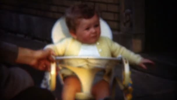 Parent playing with baby in bouncing chair — Stock Video