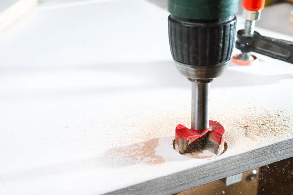 Furniture assembly. Drill with cutter make a hole in the board — Stock Photo, Image