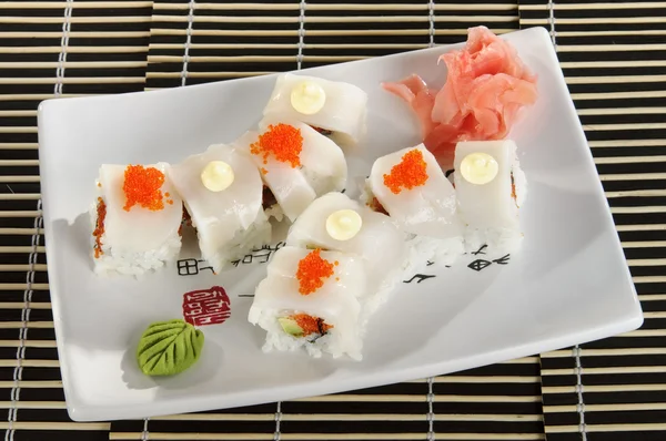 Sushi menu: a set of rolls of scallops with wasabi and ginger on a plate — Stock Photo, Image