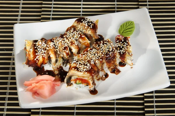 Sushi menu set poliyh rolls with soy sauce and sesame and ginger on a plate — Stock Image Sushi menu set poliyh rolls with soy sauce and sesame and ginger on a plate Royalty Free Stock Images