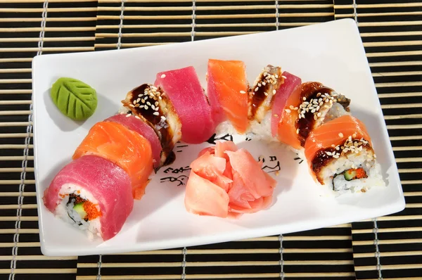 Sushi menu: a set of rolls with assorted wasabi and ginger on a plate — Stock Image Sushi menu: a set of rolls with assorted wasabi and ginger on a plate Stock Photo