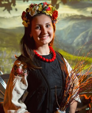 Ukrainian girl in national costume in a flower wreath clipart