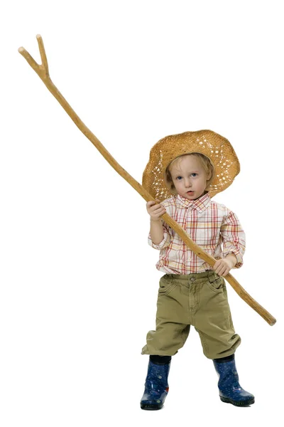 Country boy in a straw hat and a stick in his hands on a white background — Stock Photo, Image