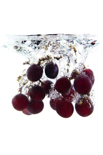 Bunch of grapes falling in the water — Stock Photo, Image