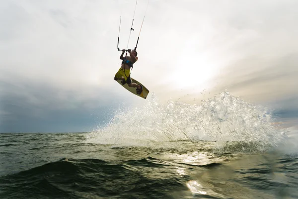 Surfer jumping at the sunset