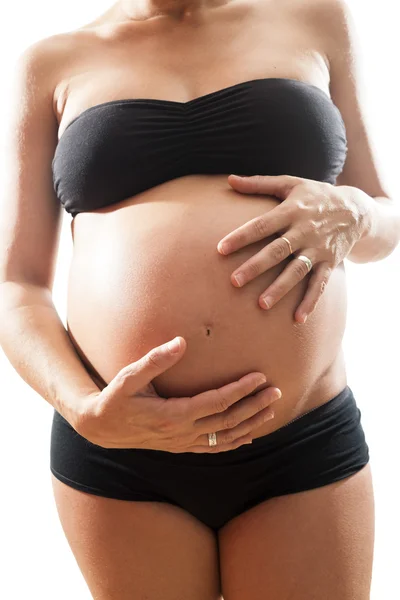 Pregnant touching her tummy — Stock Photo, Image