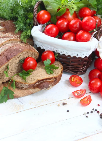 Čerstvá cherry rajčata, bylinky a bílý chléb — Stock fotografie